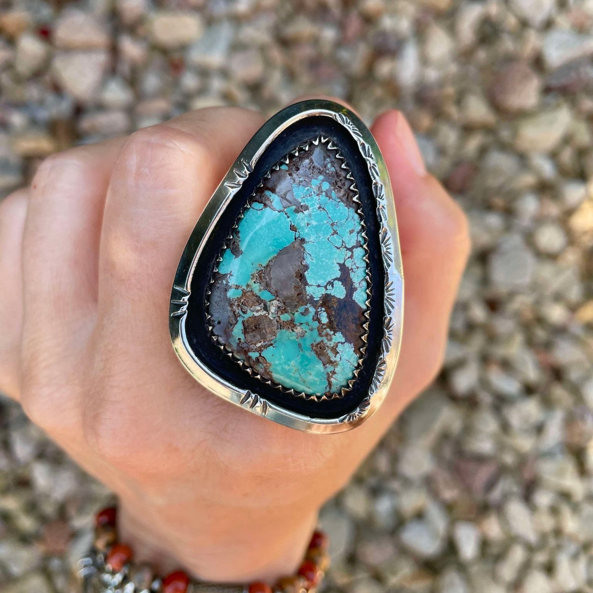 Large Kingman turquoise set in shadowbox setting on split shank ring band. Hand stamped designs.