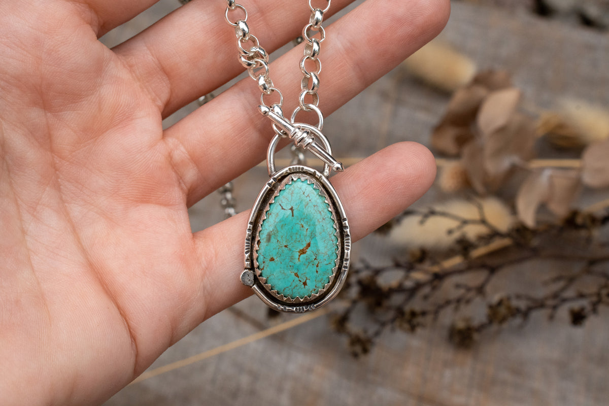 Tyrone turquoise set in sterling silver on a belcher chain necklace with toggle clasp. 