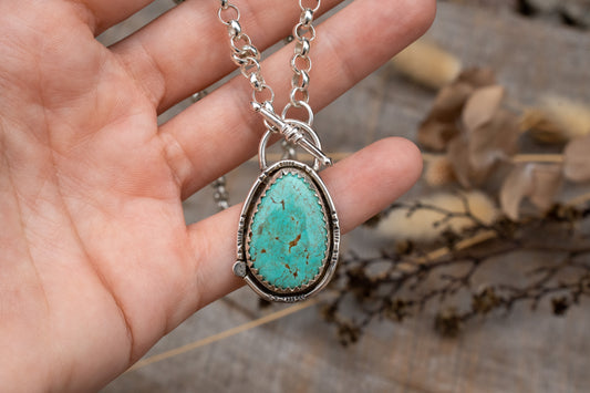 Tyrone turquoise set in sterling silver on a belcher chain necklace with toggle clasp. 