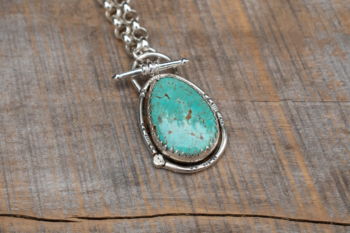 Tyrone turquoise set in sterling silver on a belcher chain necklace with toggle clasp. 