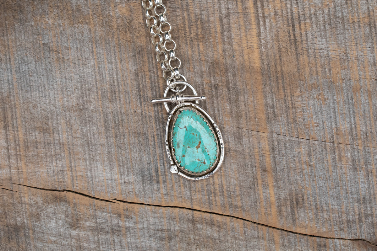 Tyrone turquoise set in sterling silver on a belcher chain necklace with toggle clasp. 